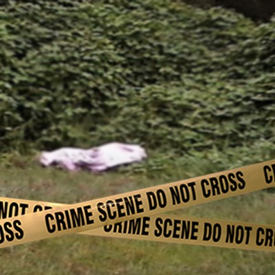 Crime scene tape in front of a covered body in a grassy location of unidentified woman found at Kelly Green development